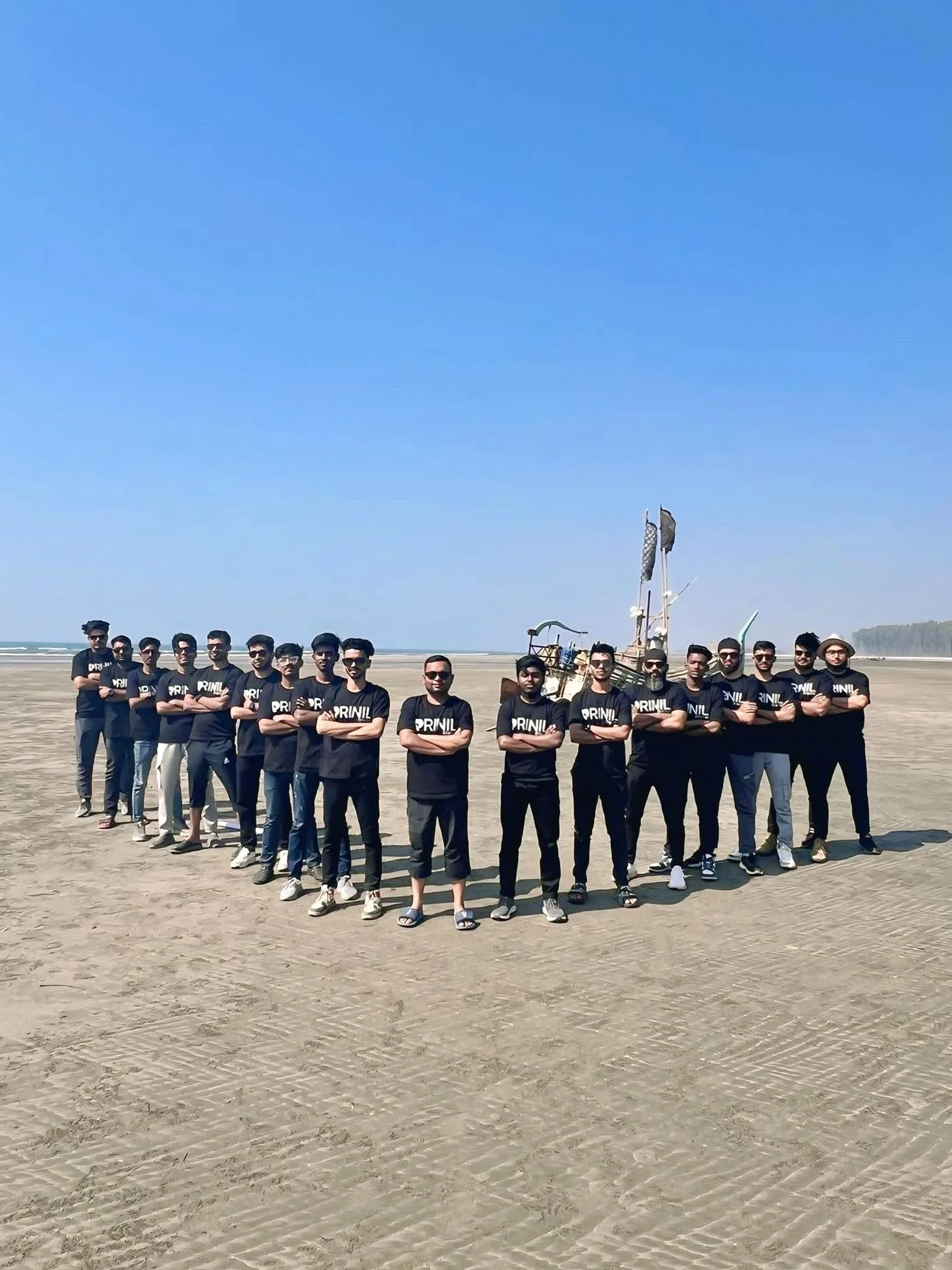 The Prinil Digital team standing together on a beach in matching Prinil shirts.